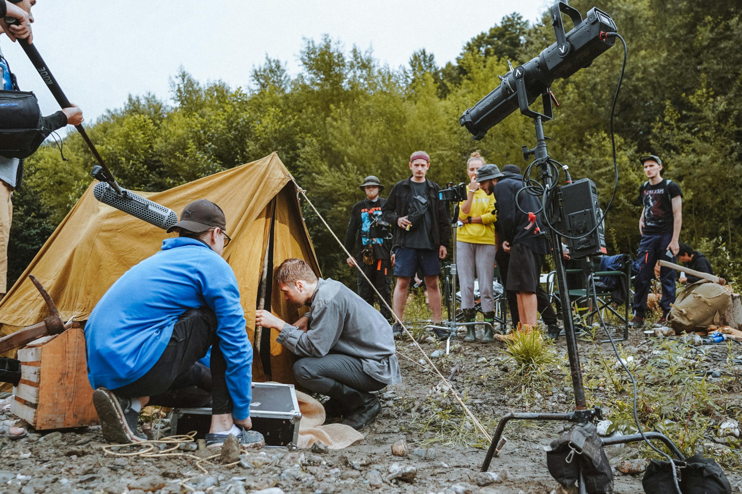 image of a film crew entering a tent